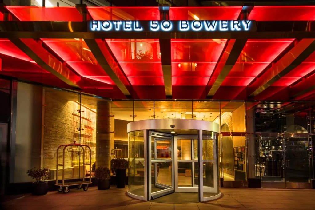 a building with a red sign on top of it at Hotel 50 Bowery, part of JdV by Hyatt in New York