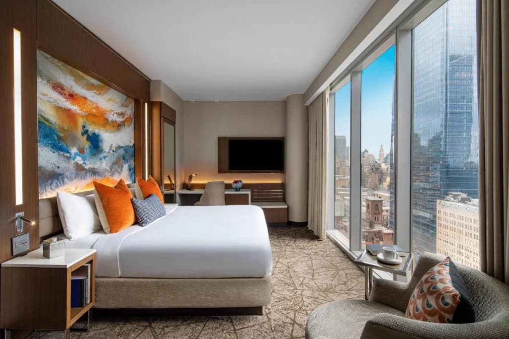 a hotel room with a bed and a large window at Courtyard New York Manhattan/Midtown West in New York