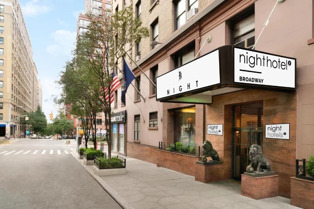 a building on a city street with a storefront at Night Hotel Broadway in New York