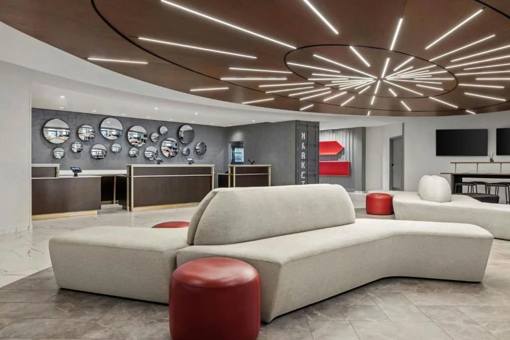 a living room with a couch and a chandelier at Renaissance Newark Airport Hotel in Elizabeth