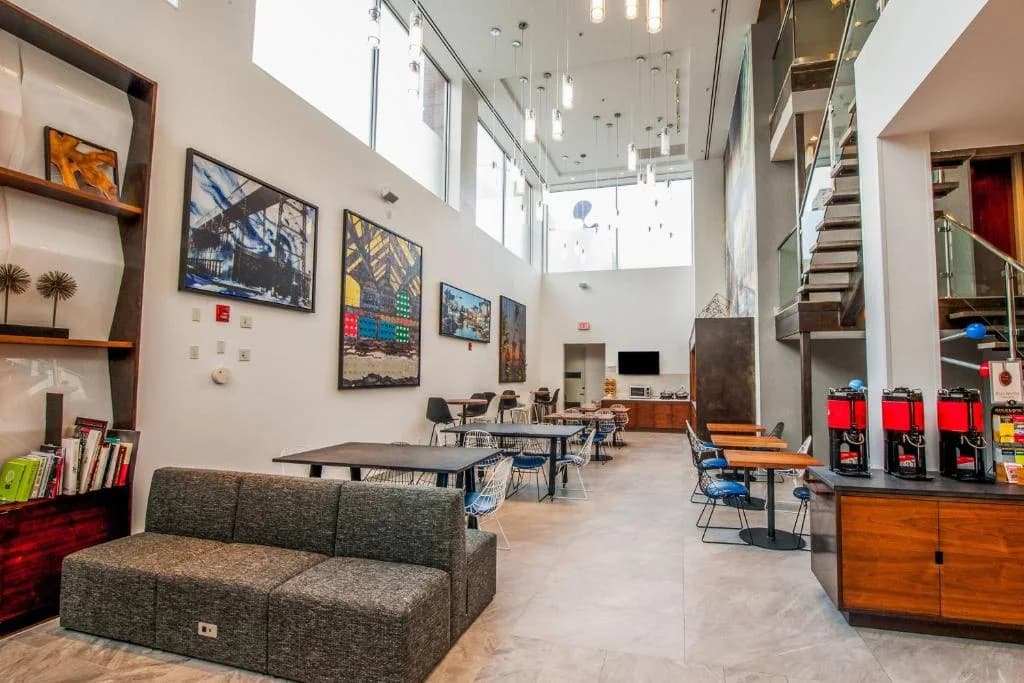 a waiting room with tables and chairs in a store at Fairfield Inn & Suites By Marriott New York Brooklyn in Brooklyn