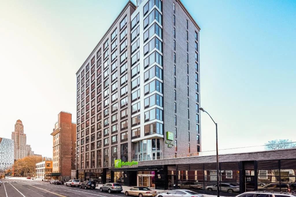 a tall building on a city street with cars at Holiday Inn Brooklyn Downtown by IHG in Brooklyn