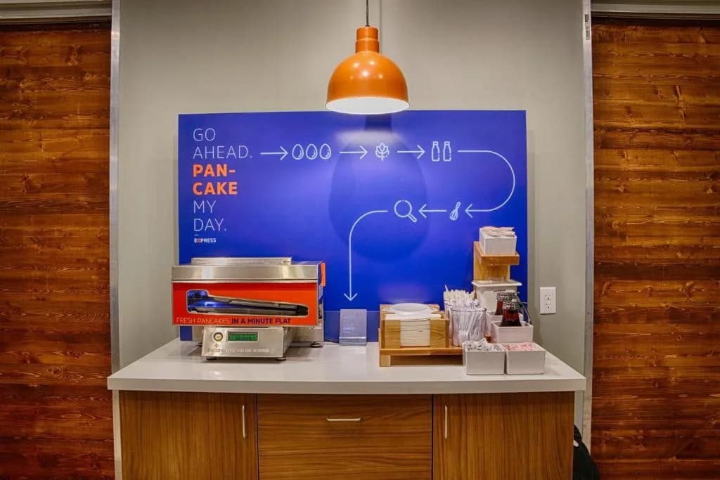 a counter with a blue board with formulas on it at Holiday Inn Express & Suites Linden - Newark South by IHG in Linden