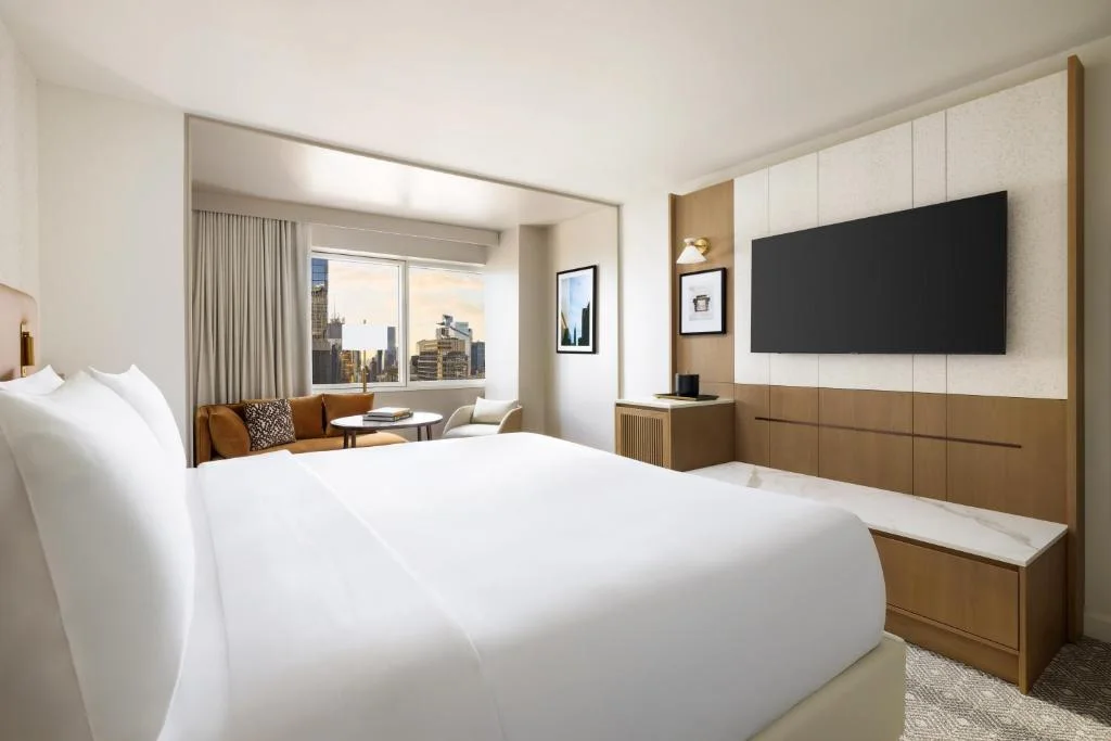a hotel room with a large bed and a television at Hyatt Regency Times Square in New York