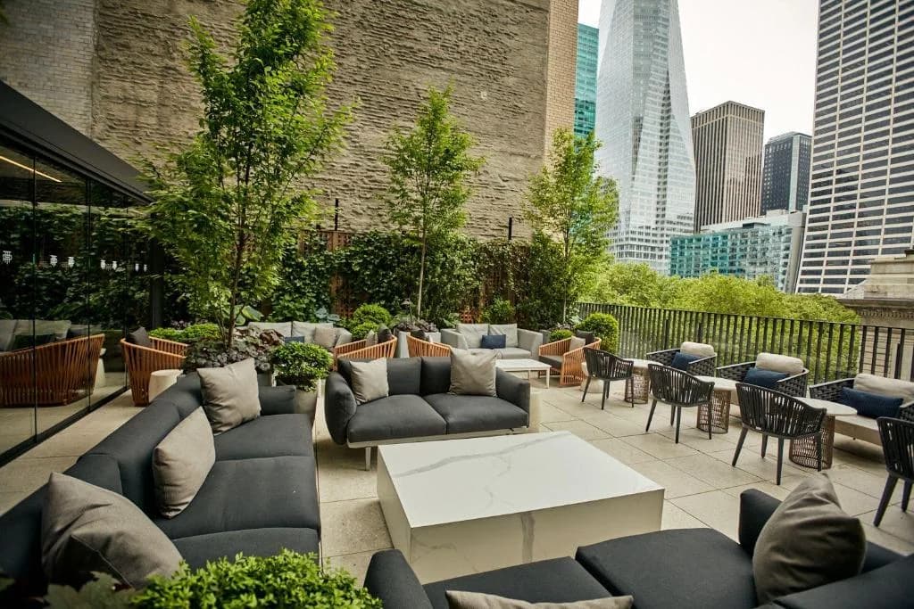 a patio with couches and tables on a building at Park Terrace Hotel in New York