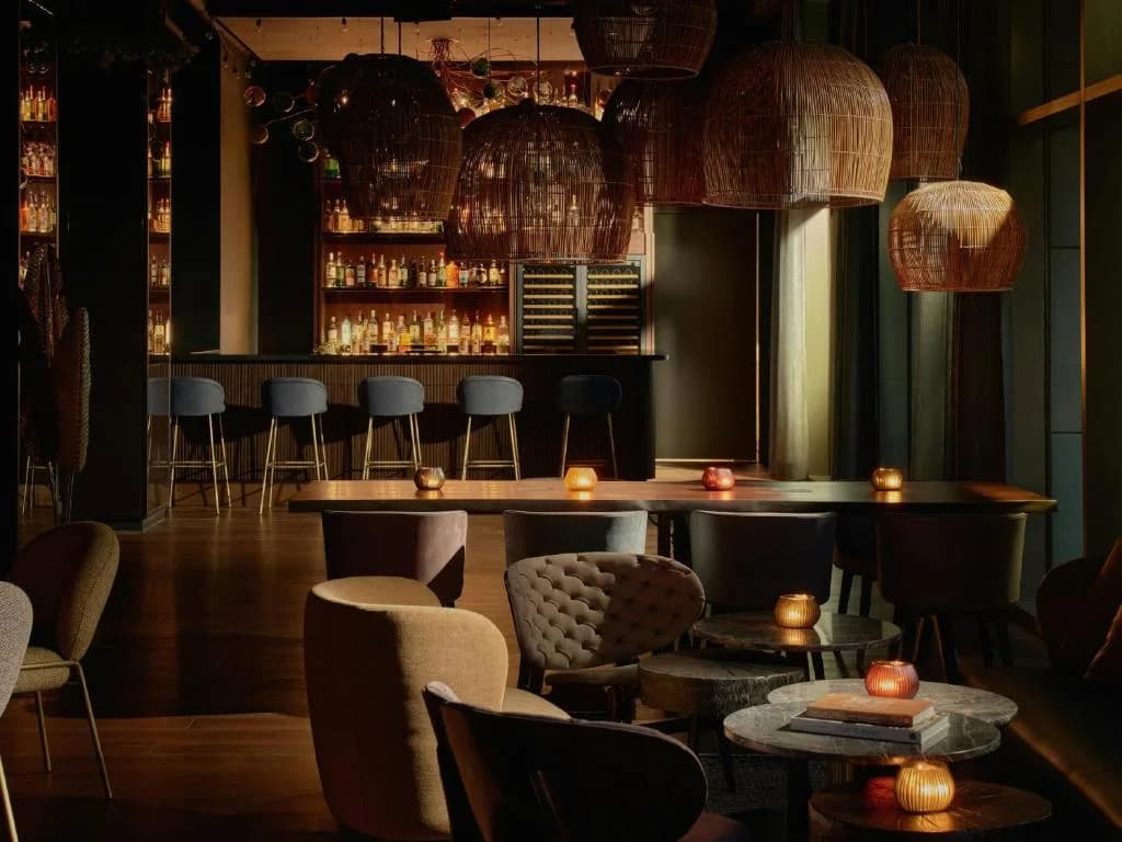 a restaurant with a bar with tables and chairs at The Cloud One New York-Downtown, part of the Motel One Group in New York
