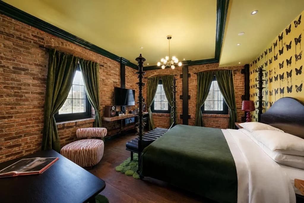 a bedroom with a bed and a brick wall at Sohotel in New York