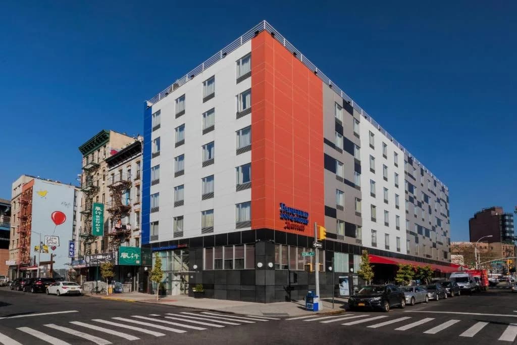 an orange and white building on a city street at Fairfield Inn & Suites New York Manhattan/Downtown East in New York
