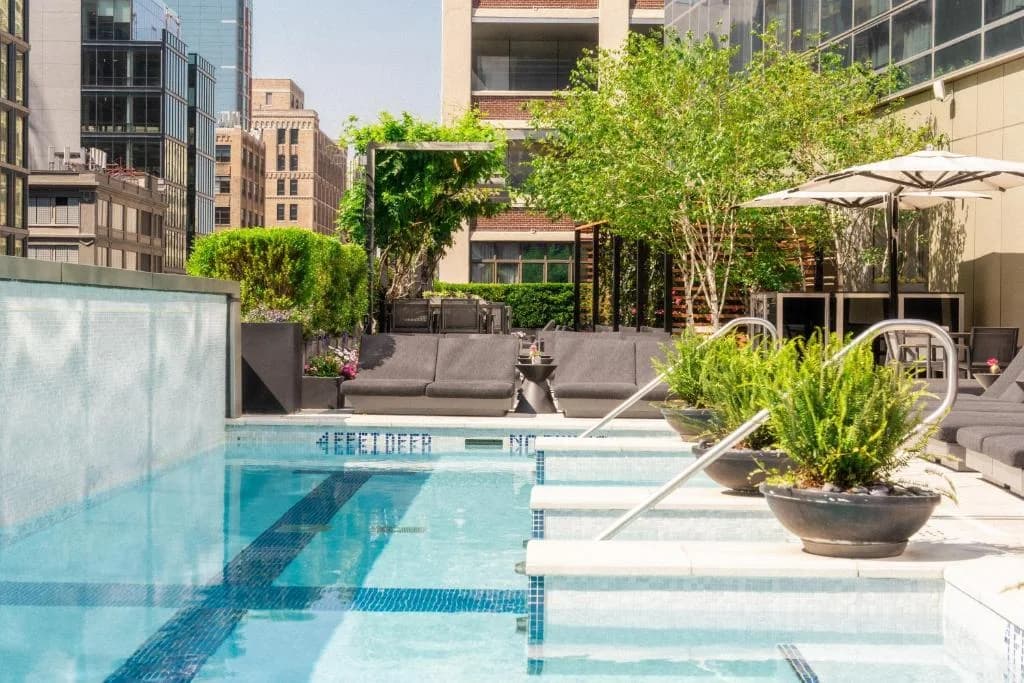 a swimming pool with umbrellas on a building at The Dominick Hotel in New York