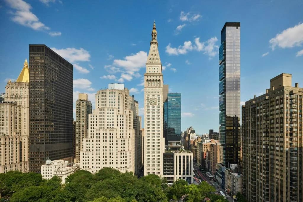 a tall building with a clock tower in a city at The New York EDITION in New York