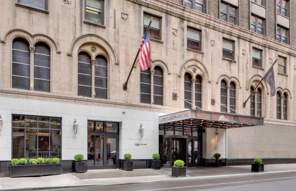 a building with an american flag in front of it at WestHouse Hotel New York, an SLH Hotel in New York