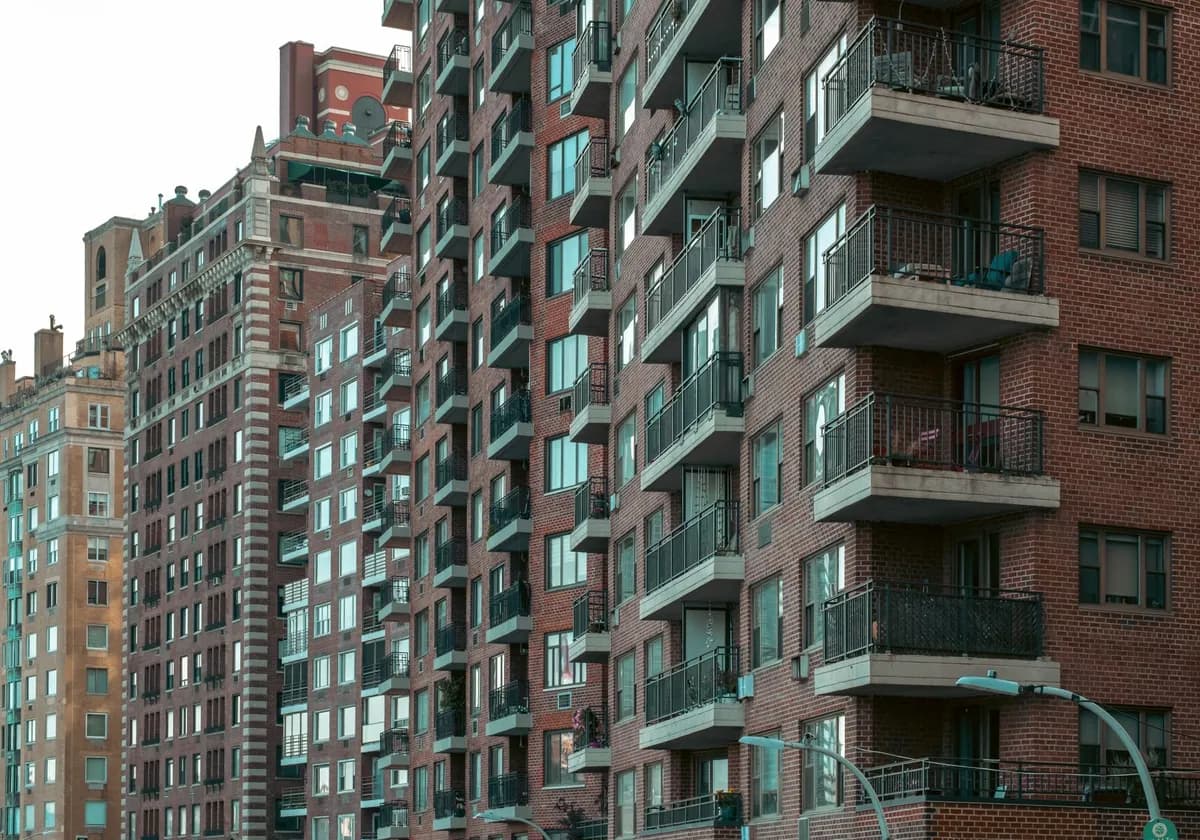 A view of urban New York City apartment buildings with balconies.