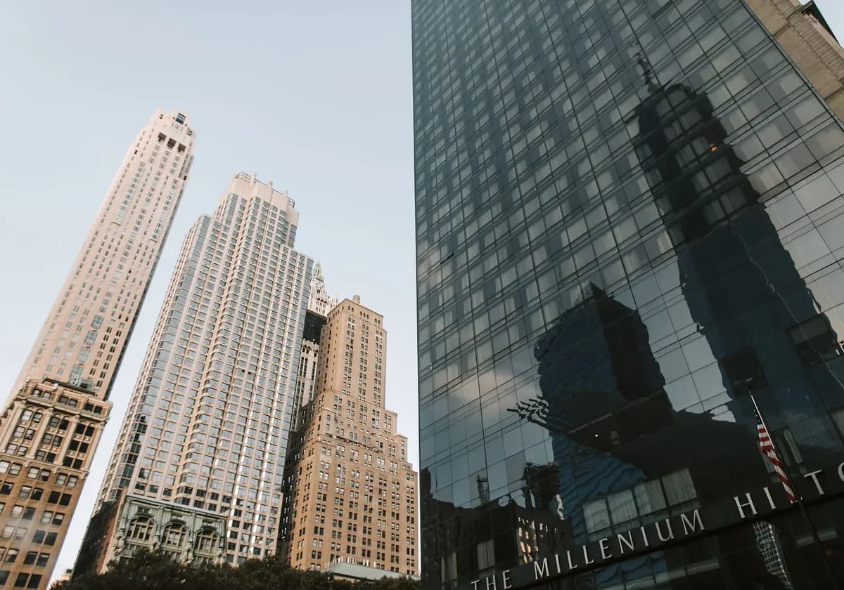 A low angle shot of New York City's skyline featuring towering skyscrapers at dusk.
