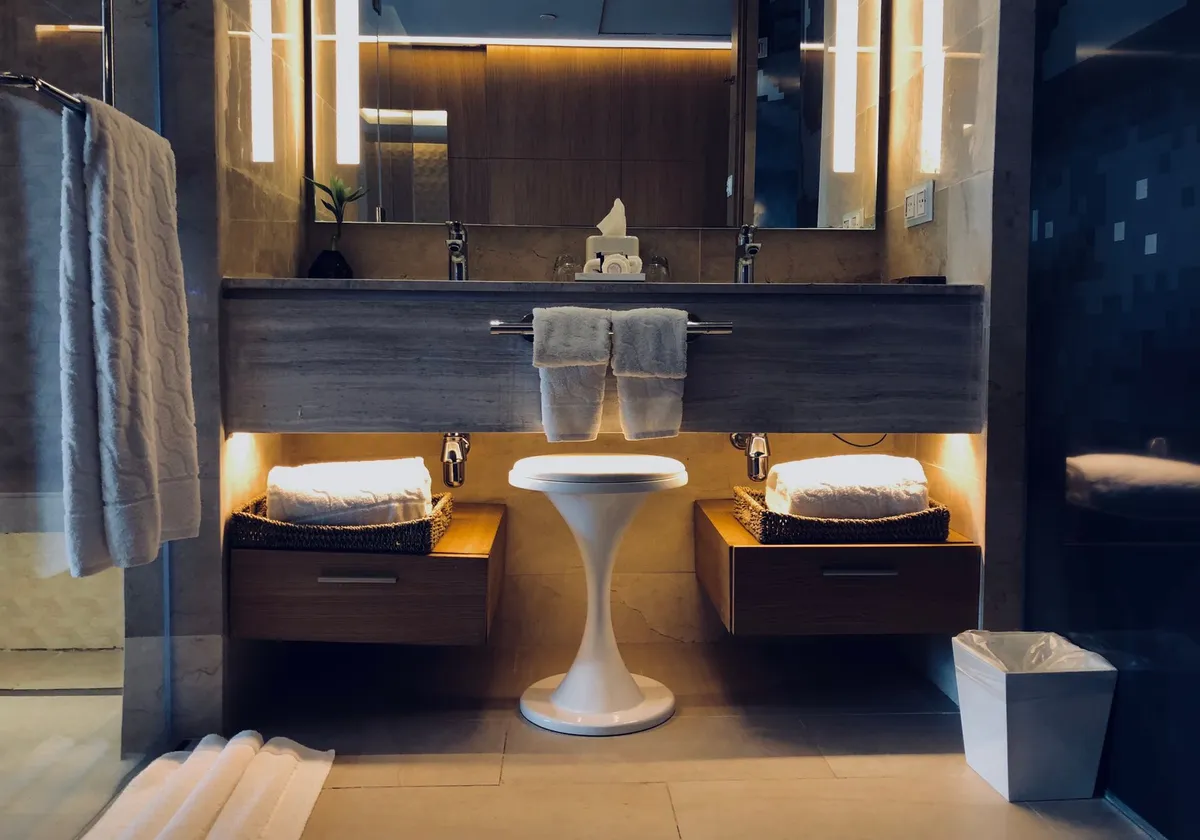 Stylish modern bathroom with illuminated vanity, mirrors, and cozy atmosphere.