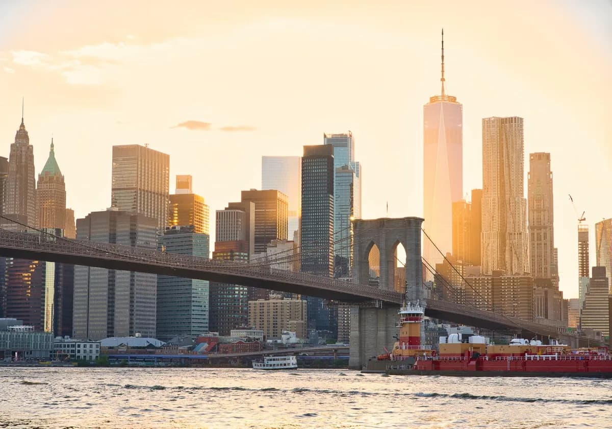 A stunning view of the Brooklyn Bridge and New York City's skyline at sunset.