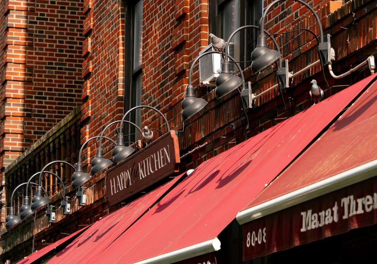 Red brick building with 'Happy Kitchen' sign in New York City