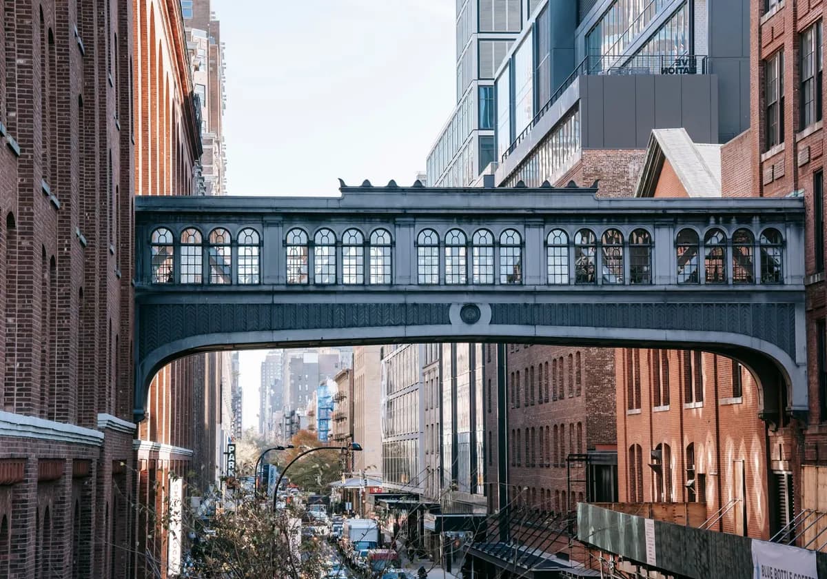 Exterior of contemporary buildings connected with bridge with windows of urban street in daytime