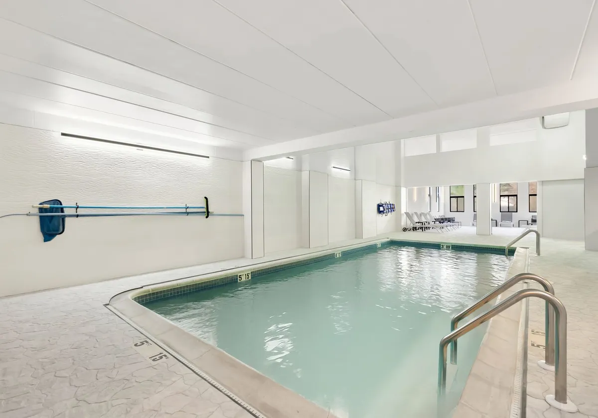 Modern indoor pool area at a hotel in Tinton Falls, NJ, USA, offering a serene swimming experience.