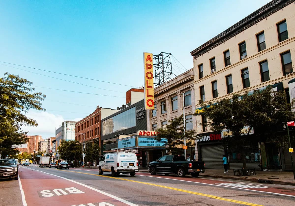 Street view of Apollo Theater in New York City, showcasing urban life and architecture.