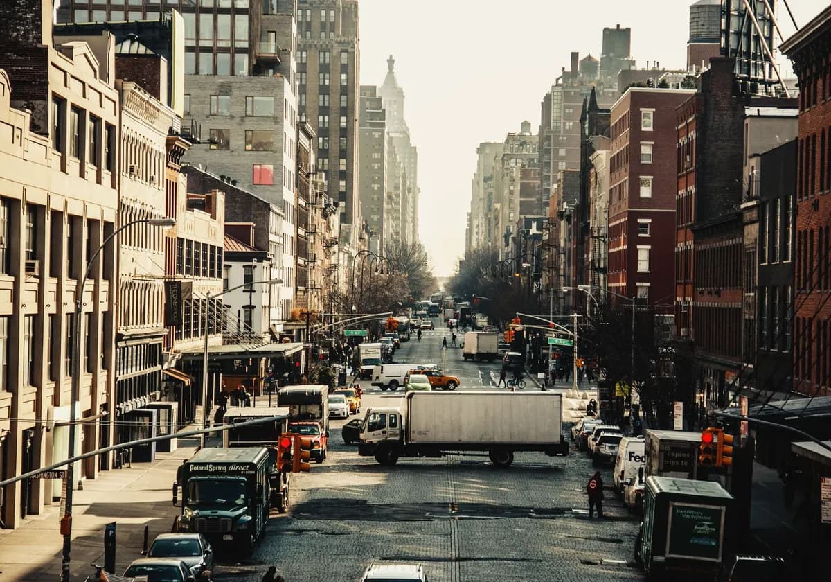 A bustling street in New York City filled with vehicles and iconic urban architecture.