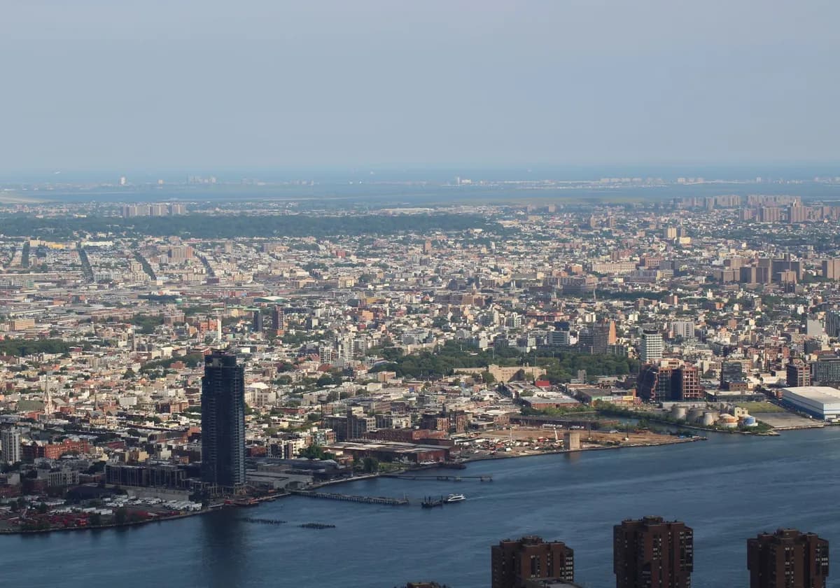 Aerial view capturing the expansive New York City skyline along the waterfront.