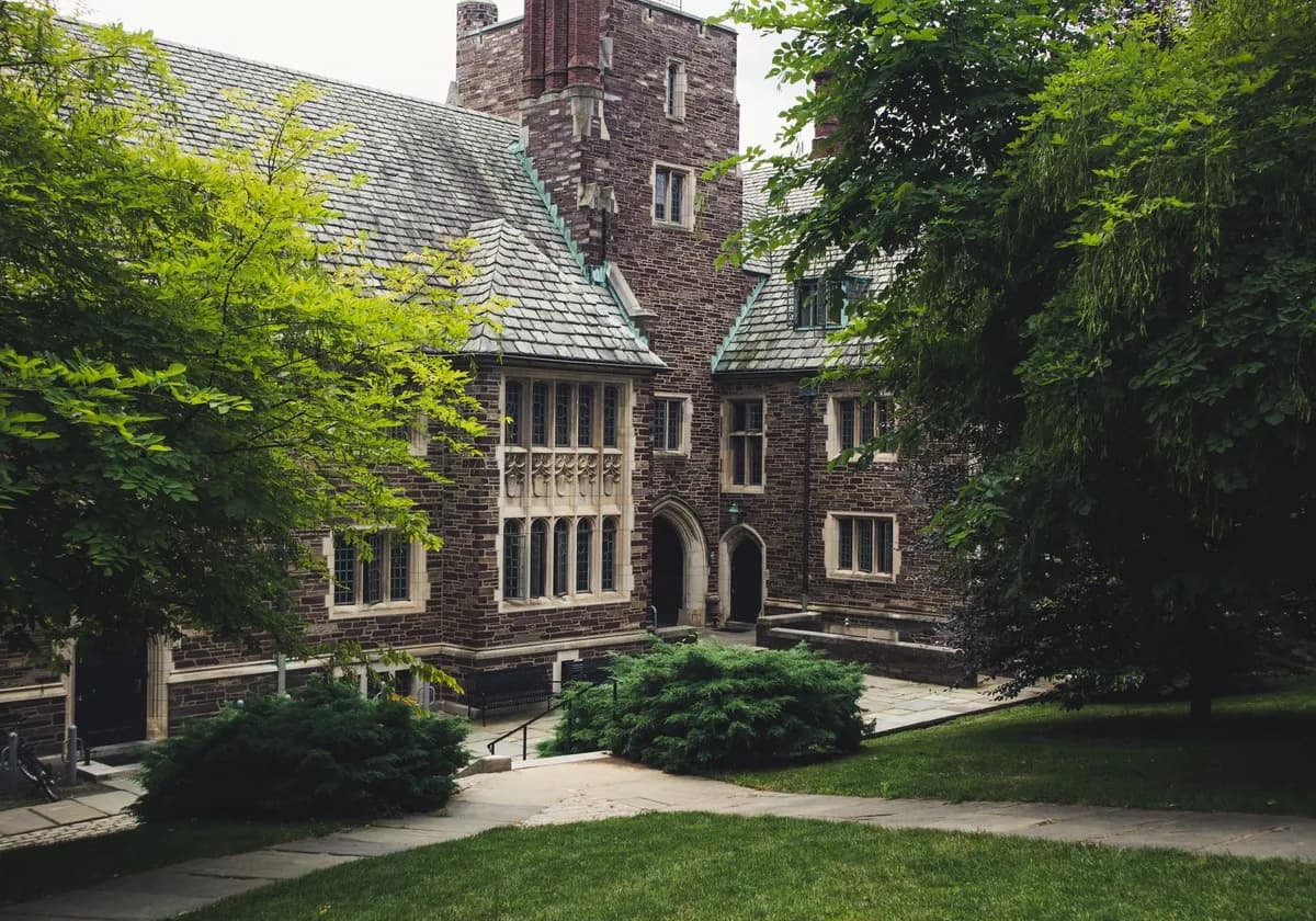 Elegant Gothic architecture of Princeton University surrounded by lush greenery on a summer day.