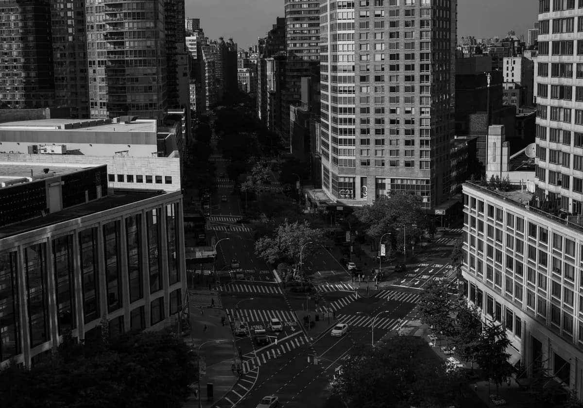 A dramatic black and white cityscape of New York City highlighting urban architecture.