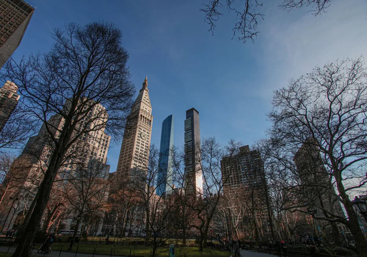 Beautiful view of New York City's famous skyline with skyscrapers and Central Park trees.