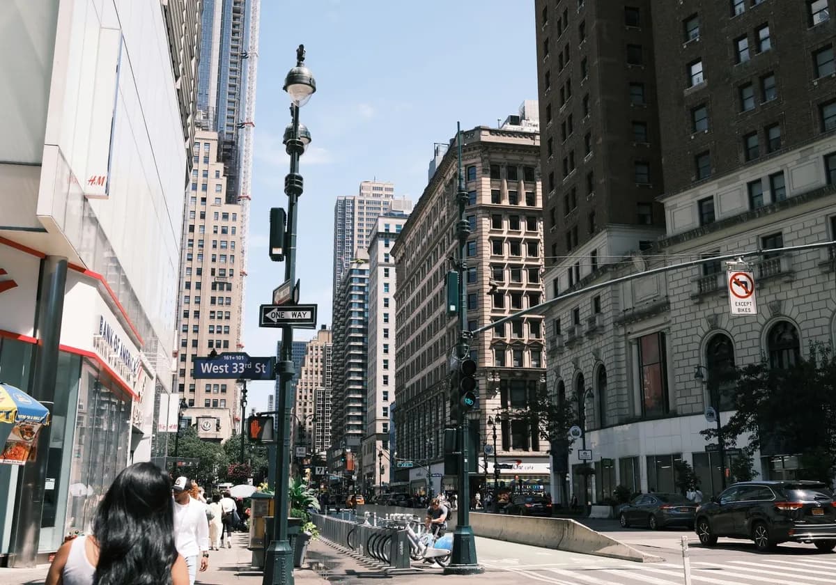 A vibrant view of West 33rd Street in New York City showcasing urban life and architecture.