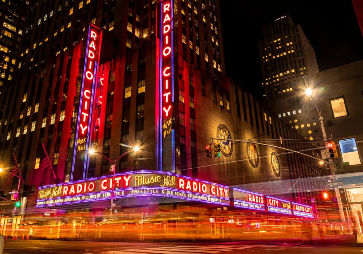 Vibrant night scene of Radio City Music Hall in NYC's Rockefeller Center.