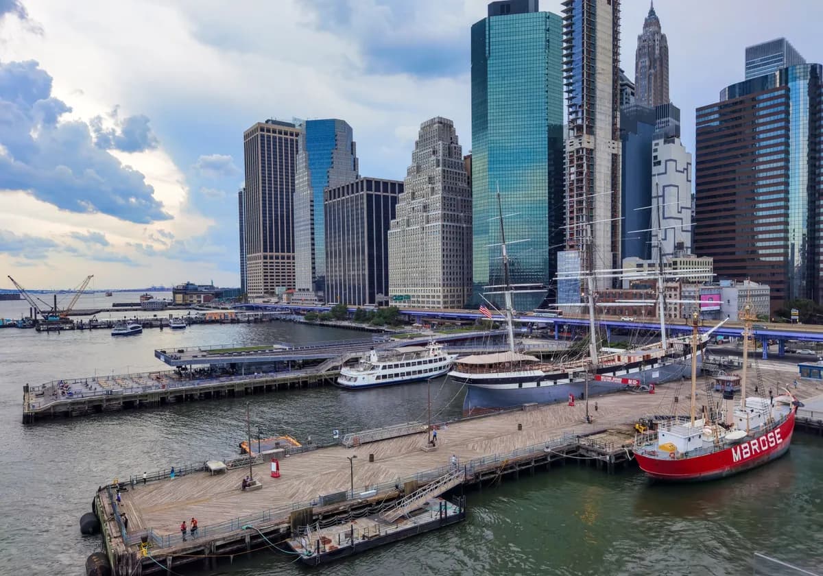 Explore the vibrant harbor with skyscrapers and boats at New York City's waterfront.