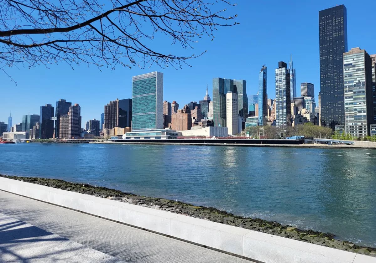 A clear day view of New York City skyline from across the river, showcasing iconic skyscrapers.