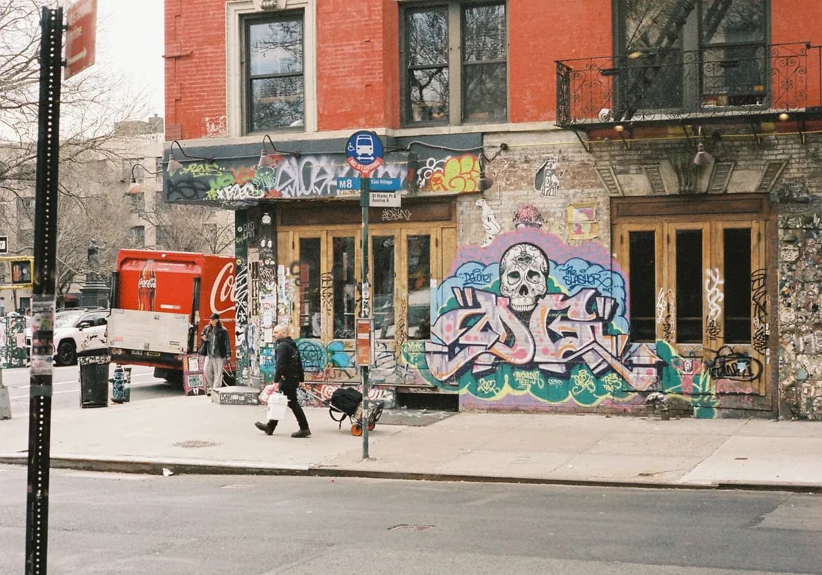Dynamic urban street corner featuring vibrant graffiti and a Coca-Cola truck.