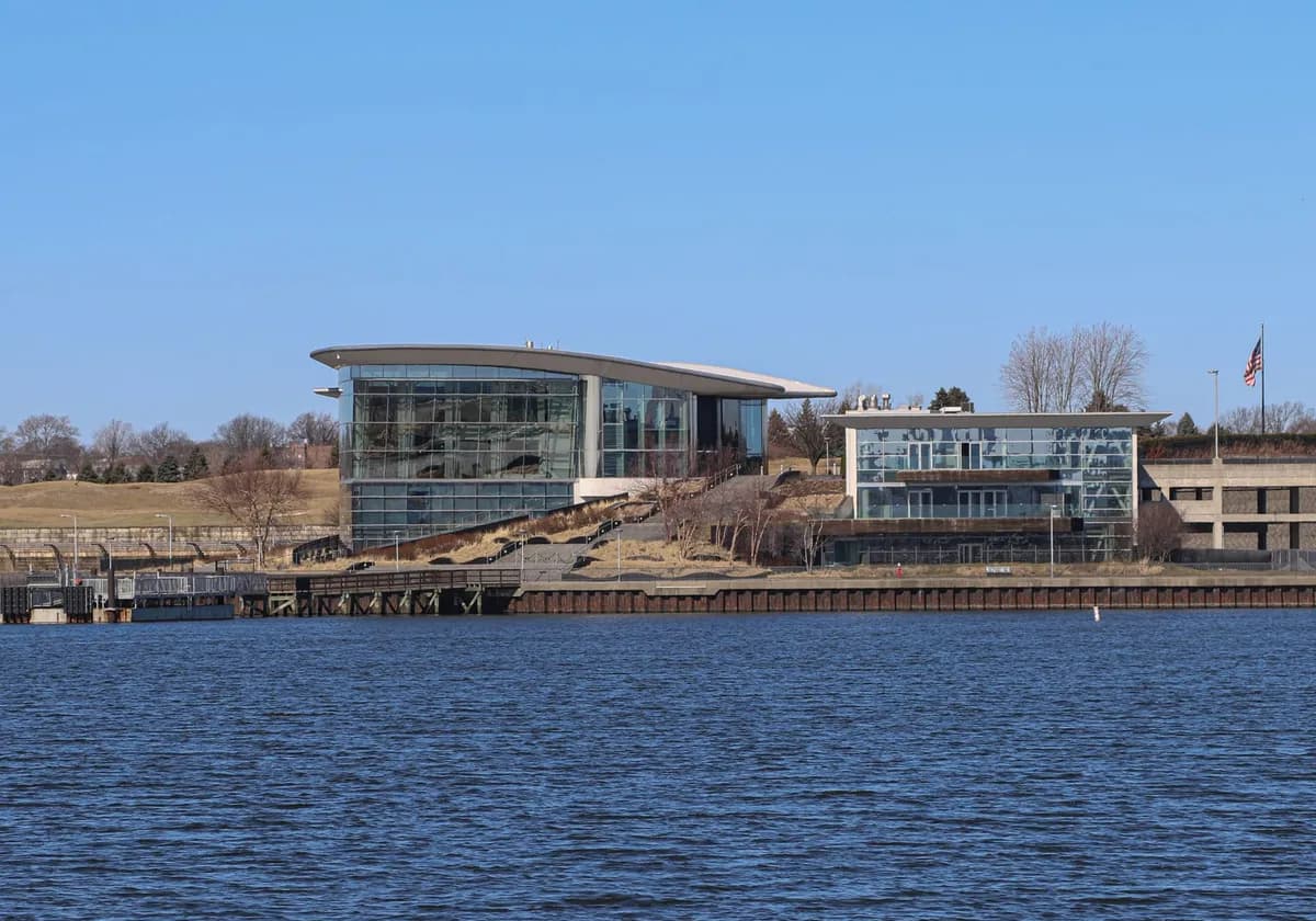 Contemporary buildings along the Jersey City waterfront with clear blue skies.