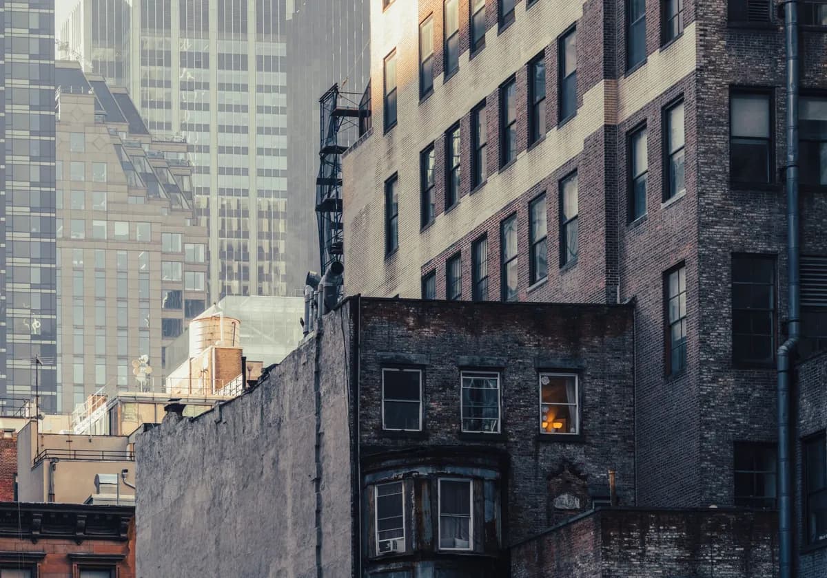 Dramatic view of contrasting architectural styles at dusk in New York City.