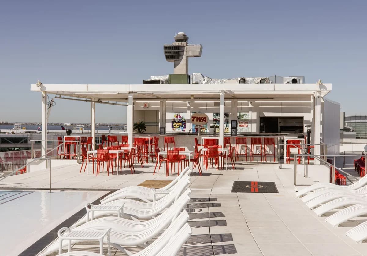 Discover the sunlit luxury rooftop bar at TWA Hotel, offering stunning views and modern amenities in New York City.