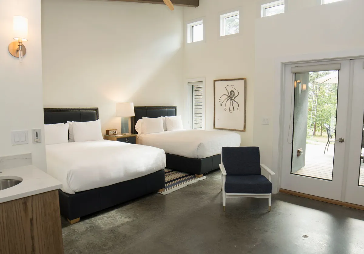 Inviting bedroom with twin beds and contemporary design in Hampton Bays, New York.