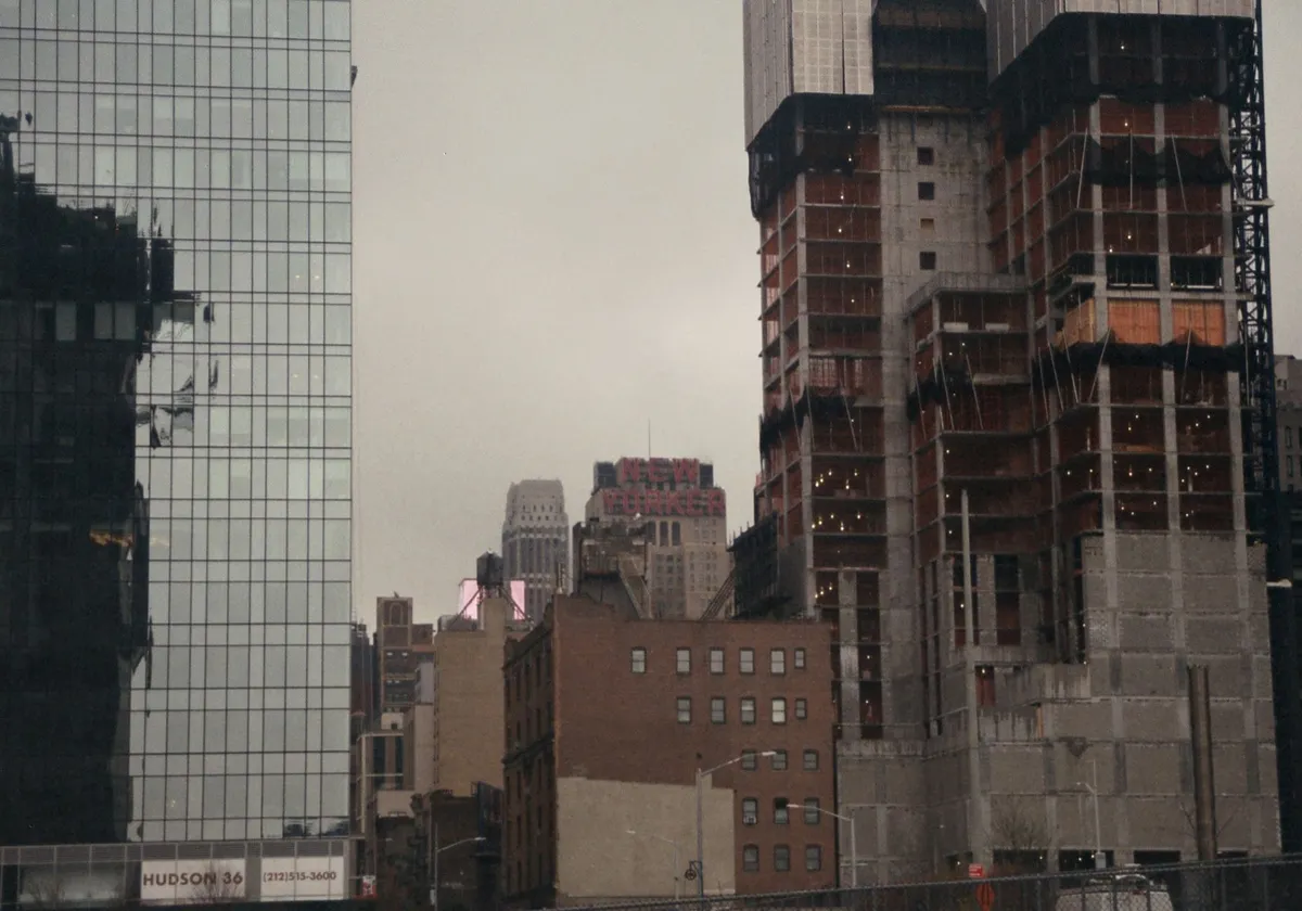 Tall contemporary building on restoration in big city under gloomy cloudy gray sky