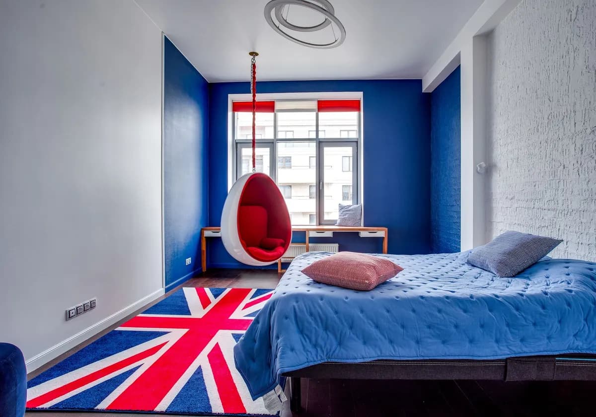 Contemporary bedroom featuring a Union Jack carpet, modern design, and cozy hanging chair.