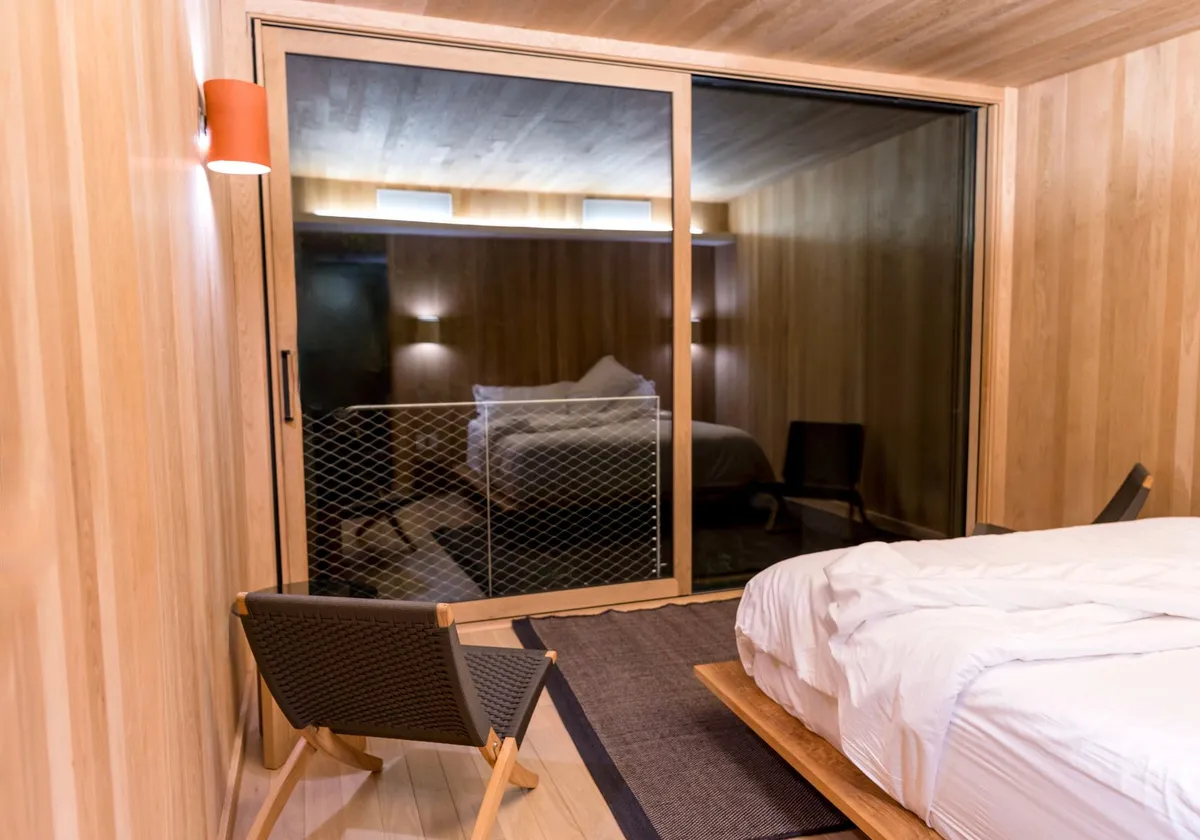 A stylish modern bedroom with wooden decor and sleek furniture for a serene ambiance.