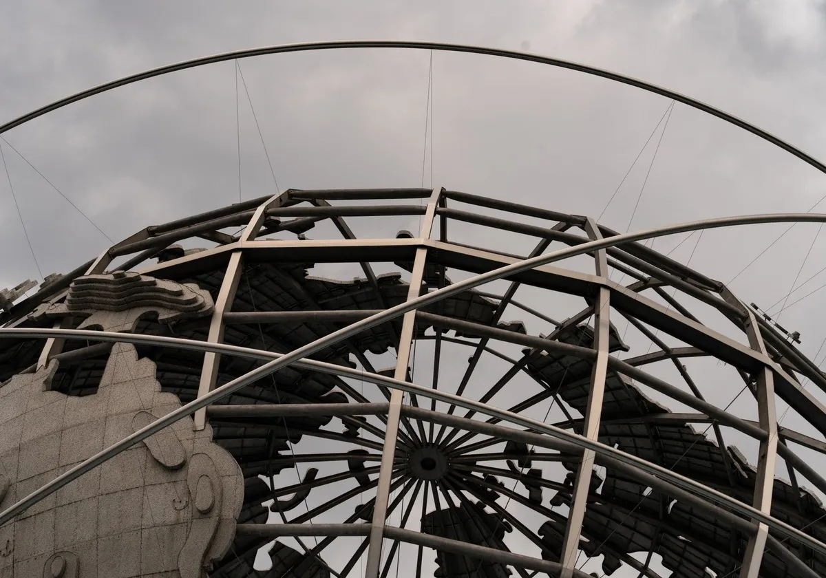 Detailed view of the Unisphere globe with overcast skies, showcasing intricate metal framework.
