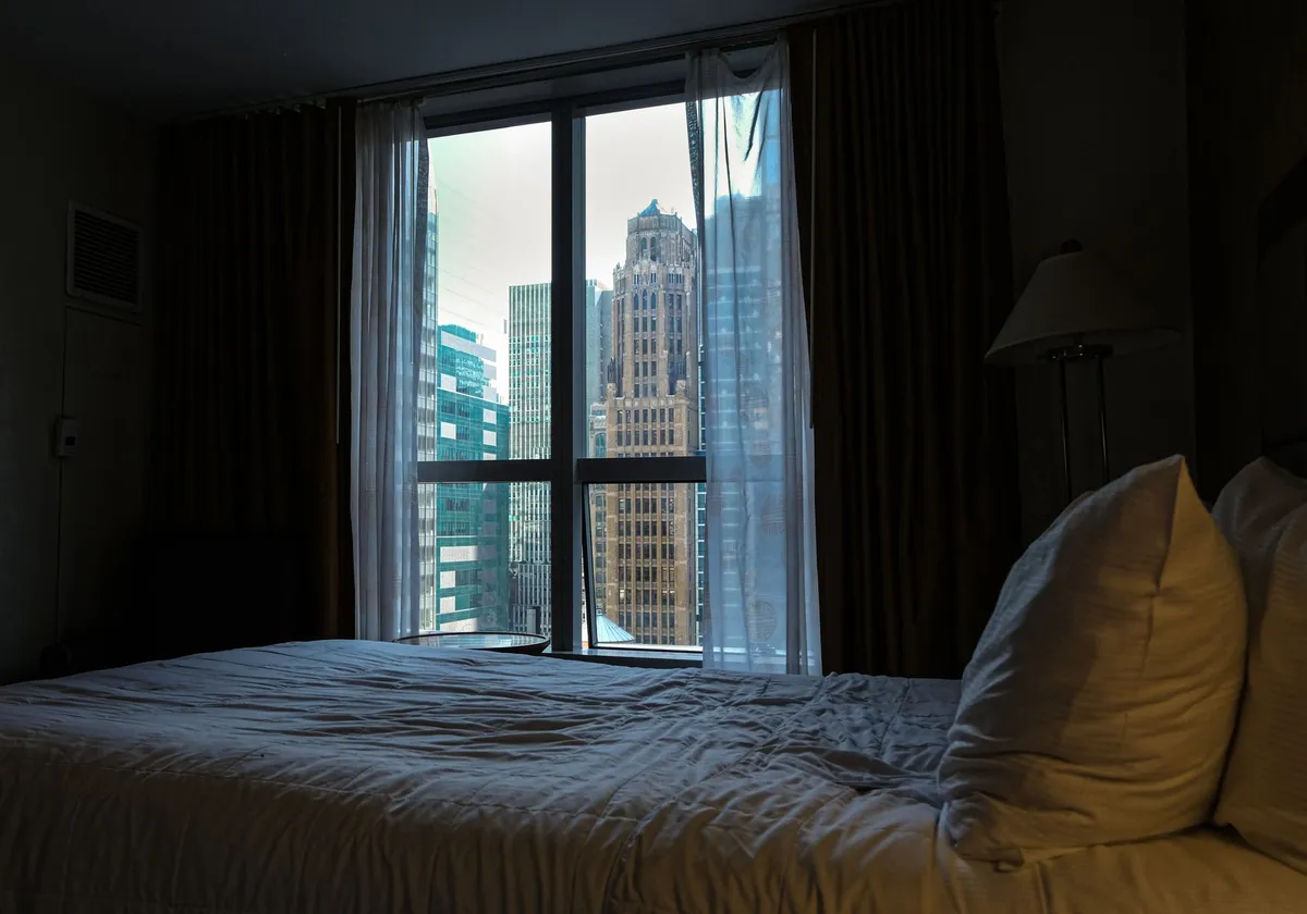 City view from a cozy hotel room in New York City, offering an urban skyline perspective.